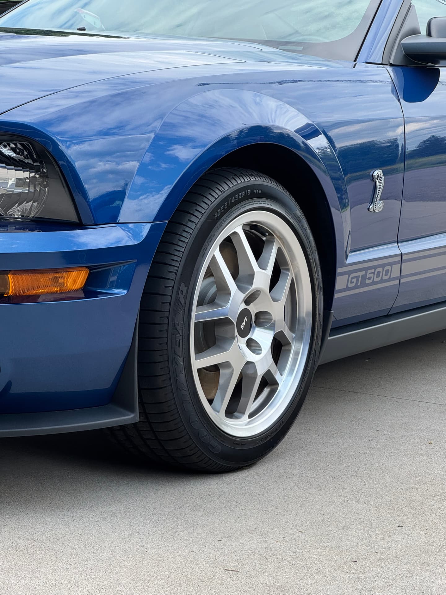 Close-up of a freshly cleaned blue Shelby GT500 wheel and tire after hand detailing